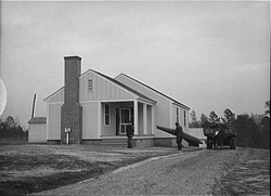 Mr. William Howard supervises the men moving his household goods into a new house at Gardendale, Alabama